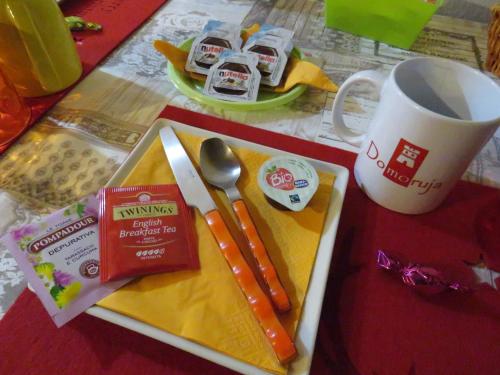 a table with a plate of food and a cup of coffee at Domoruja B&B in Sassari