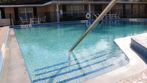 a swimming pool with a pole in the water at Magic Key - Near Disney in Kissimmee