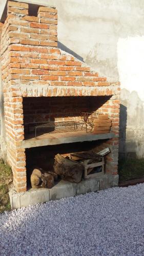 un horno de ladrillo al aire libre con una pila de troncos en Munaywasy monoambiente para dos, en Piriápolis