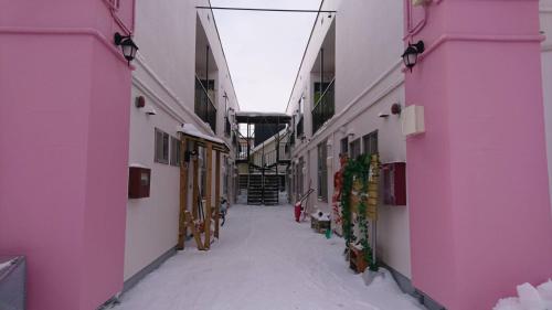 an empty hallway with snow in the middle of a building at Happy Apartment in Sapporo
