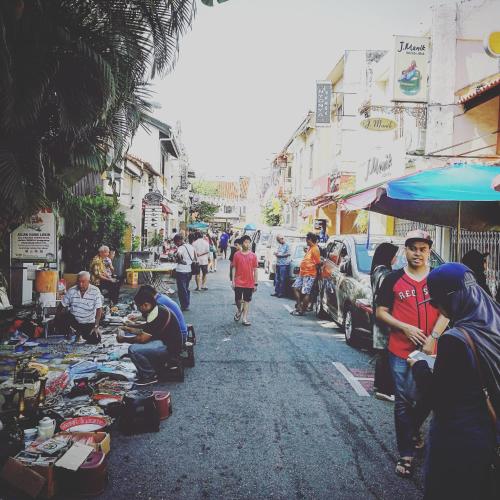 a group of people standing around a street market at LEJU 8 樂居 Loft living with open air bathroom in Melaka