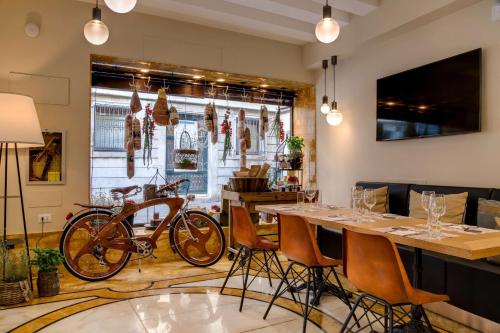 a room with a table with a bike parked in it at BW Premier Collection CHC Continental in Venice