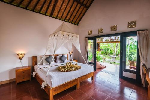 a bedroom with a bed with a bunch of bananas on it at Arta Nadi Villa in Sidemen