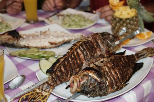a plate of food with fish on a table at Athiriveli in Thoddoo