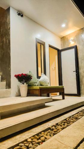 a room with stairs and a bench and a mirror at Mimi House in Hoi An