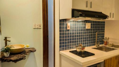 a small kitchen with a sink and a stove at Mimi House in Hoi An