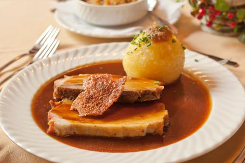 a plate of food with bread and sauce on a table at Hotel Gasthof Post in Nesselwang
