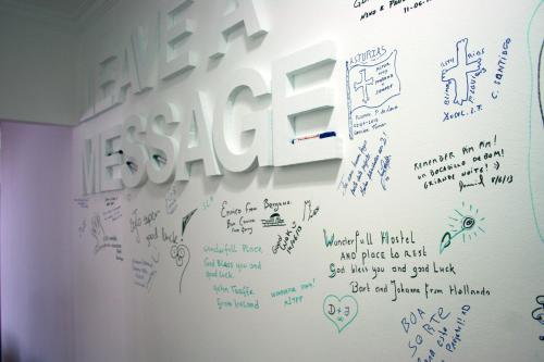 a white wall with writing on it at Hostel 2300 Thomar in Tomar