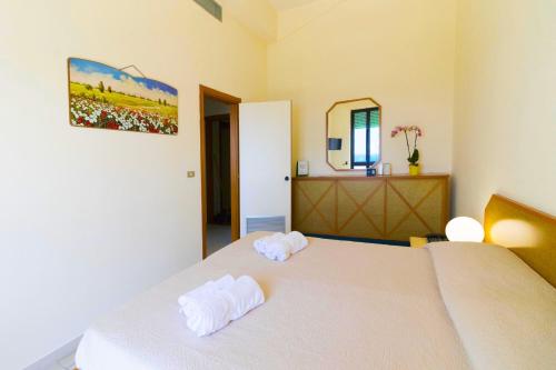 a bedroom with a bed with two towels on it at Albergo Palazzo in Santa Cesarea Terme