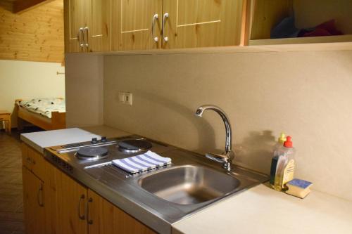 a kitchen with a sink and a counter top at Penzión nad Skalicou in Skalica