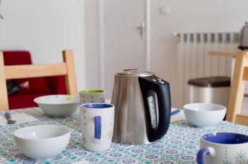 een koffiepot zittend op een tafel met kopjes bij Villa Vincenzo Di Meglio in Ischia