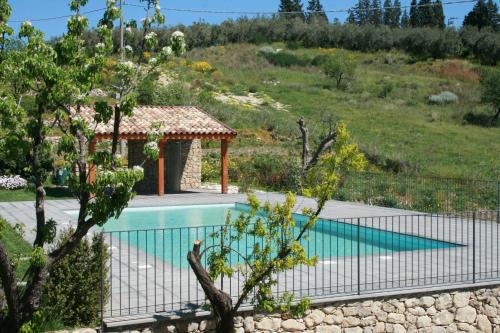 a fence around a swimming pool with a gazebo at Vecchia Dimora Resort in Centuripe