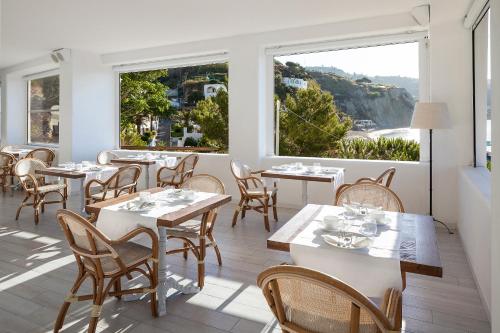 a restaurant with tables and chairs and a large window at Apollon Club & Thermal Spa in Ischia