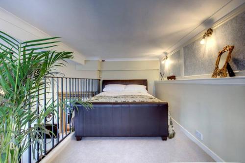 a bedroom with a bed on a balcony at Carnegie Library: Bronte Apartment 1 bedroom in Swinton