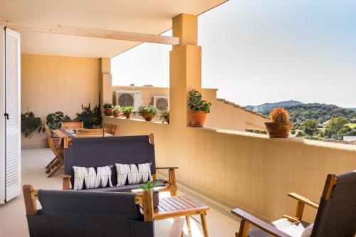 a balcony with a couch and a table at Appartamenti Shardana in Villasimius
