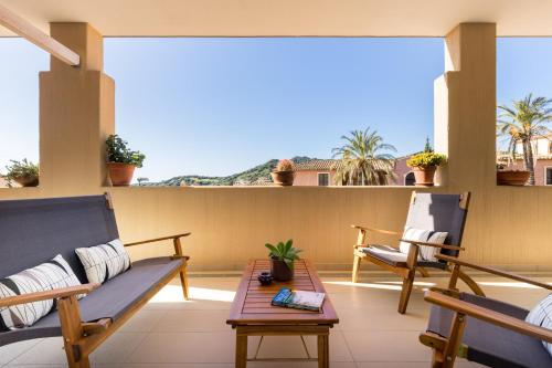 a balcony with two chairs and a table at Appartamenti Shardana in Villasimius