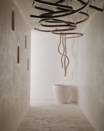 a metal chandelier hanging from a ceiling in a room at The Alpina Gstaad in Gstaad