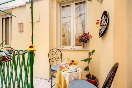 a table with a cup of tea on a balcony at Hotel Giotto Flavia in Rome