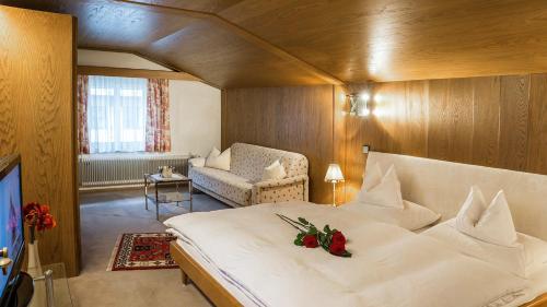 a bedroom with a large white bed with roses on it at Appartment Eichhorn in Sankt Anton am Arlberg