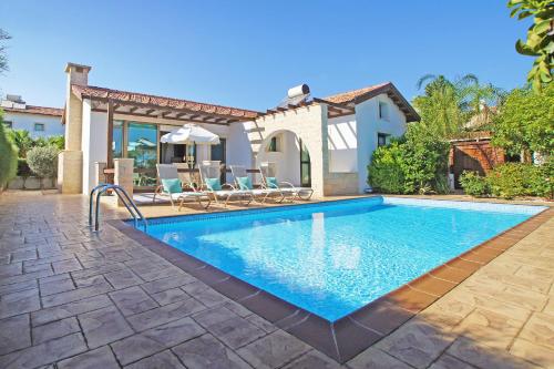 a swimming pool in front of a villa at Villa Louisa in Ayia Napa