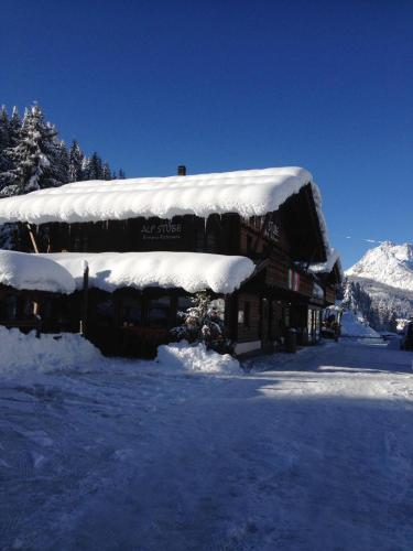 a snow covered building with a snow covered roof at Eirl DOLOMITES Retreat Sappada in Sappada