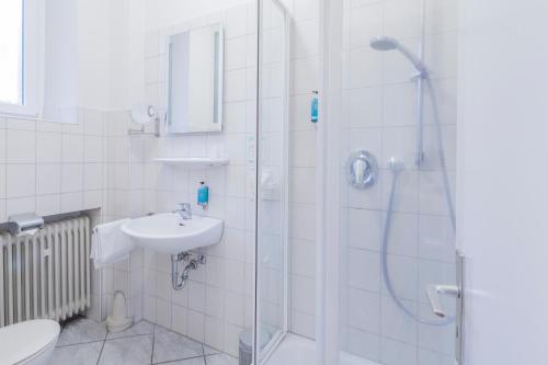 ein Bad mit einer Dusche und einem Waschbecken in der Unterkunft Alleehaus in Freiburg im Breisgau