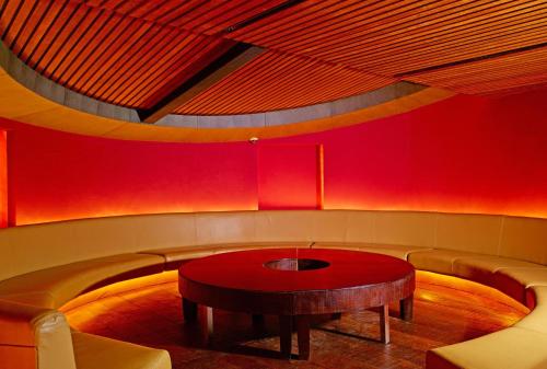 a red room with a table and a couch at Grand Hotel in Cochin