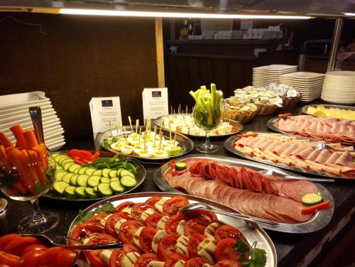 a table topped with different types of food at Hotel Atlas Sport in Garmisch-Partenkirchen