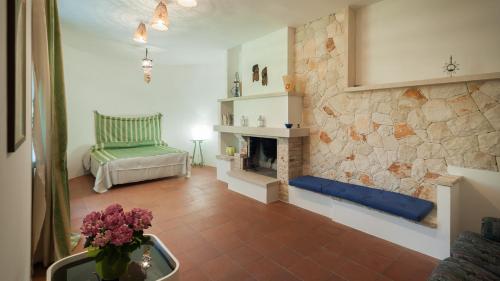 a living room with a fireplace and a chair at Dependance Santa Caterina - Nardò in Santa Caterina di Nardò
