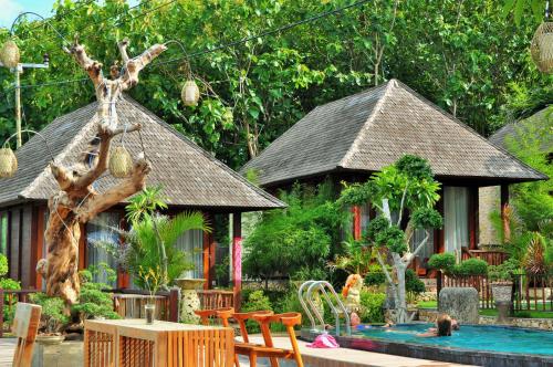 a resort with a swimming pool and a house at Ocean Terrace Suite And Spa Luxury in Nusa Penida
