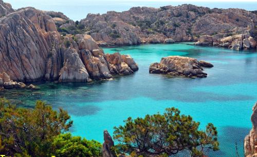 a view of a bay with rocks and blue water at Apartment Luisa in Tergu