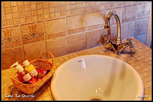 a sink with a faucet and a basket on a counter at Casa La Querola in Morella