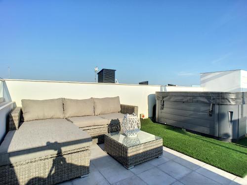 a couch and a table on a patio at Olivar de Roda Golf - Villa - 1409 in Roda