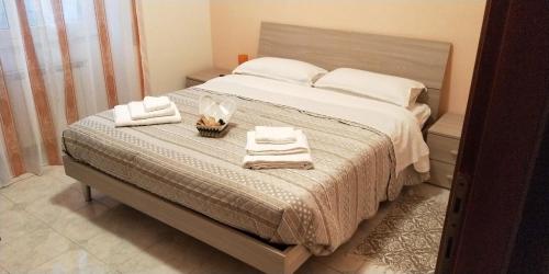 菲烏米奇諾的住宿－Isola Verde Guest House，一间卧室配有一张大床和毛巾