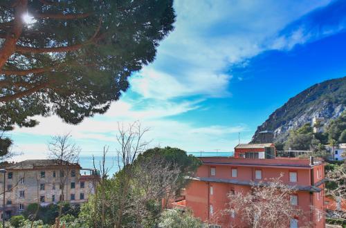 an orange building in front of a mountain at Costamare in Monterosso al Mare