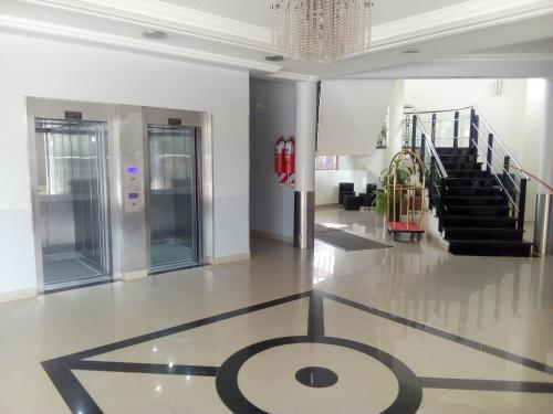 an empty lobby with a staircase and a lobby at Hotel Le Park in San Miguel de Tucumán