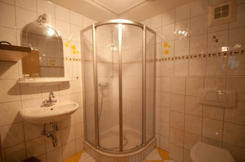 ein Bad mit einer Dusche und einem Waschbecken in der Unterkunft Haus Fritzenwallner Appartement 2 in Wagrain