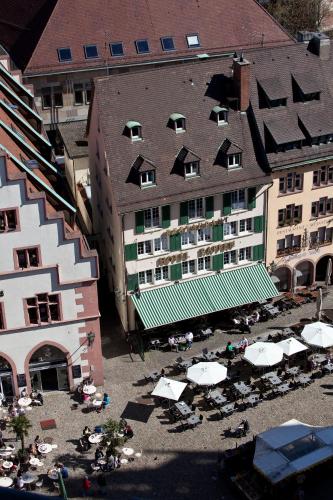 an aerial view of a hotel with tables and umbrellas at Hotel Rappen am Münsterplatz in Freiburg im Breisgau
