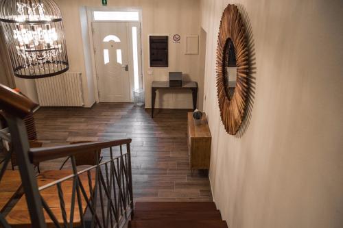 a hallway with a mirror on the wall and a table at L’infinito residence in Castelvetro Piacentino