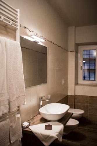 a bathroom with a white sink and a mirror at L’infinito residence in Castelvetro Piacentino