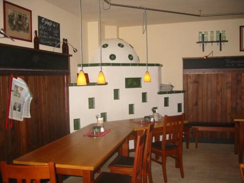 a dining room with a wooden table and chairs at Gasthof Bogenrieder in Waidhofen