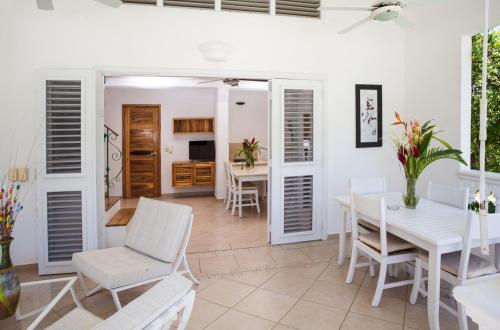 a dining room with a white table and chairs at Albachiara Hotel - Las Terrenas in Las Terrenas