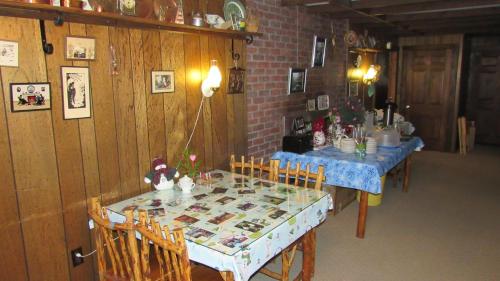 a dining room with a table and chairs with a blue table cloth at Carlson's Lodge in Twin Mountain
