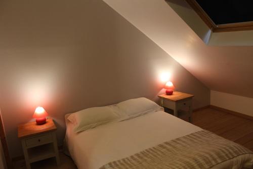 a bedroom with two red candles on two tables at Porte de Paris in Montesson