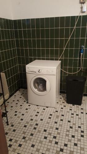 a washing machine in the corner of a bathroom at appartement de Groote Peel in Nederweert