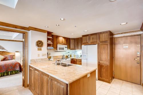 a kitchen with a sink and a bed in a room at Lodge Tower in Vail