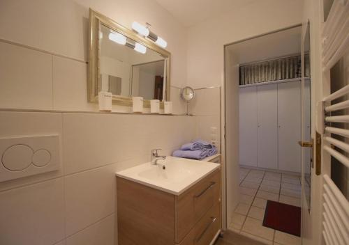 a white bathroom with a sink and a mirror at Farchanter Alm in Farchant