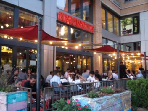 a group of people sitting at a restaurant at STEPS to CONVENTION CENTER, DOWNTOWN DC, METRO STATION: PRIVATE APARTMENT in Washington, D.C.