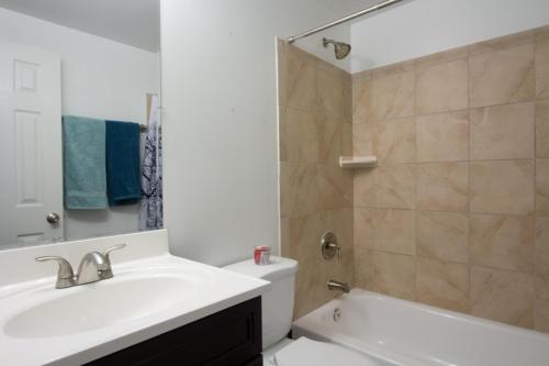 a bathroom with a sink and a toilet and a shower at STEPS to CONVENTION CENTER, DOWNTOWN DC, METRO STATION: PRIVATE APARTMENT in Washington, D.C.