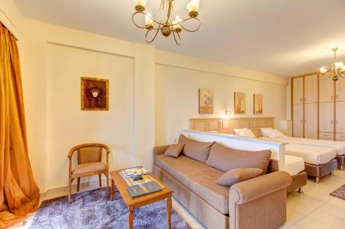a living room with a couch and a bed at Koronisia Apartments in Koronisia